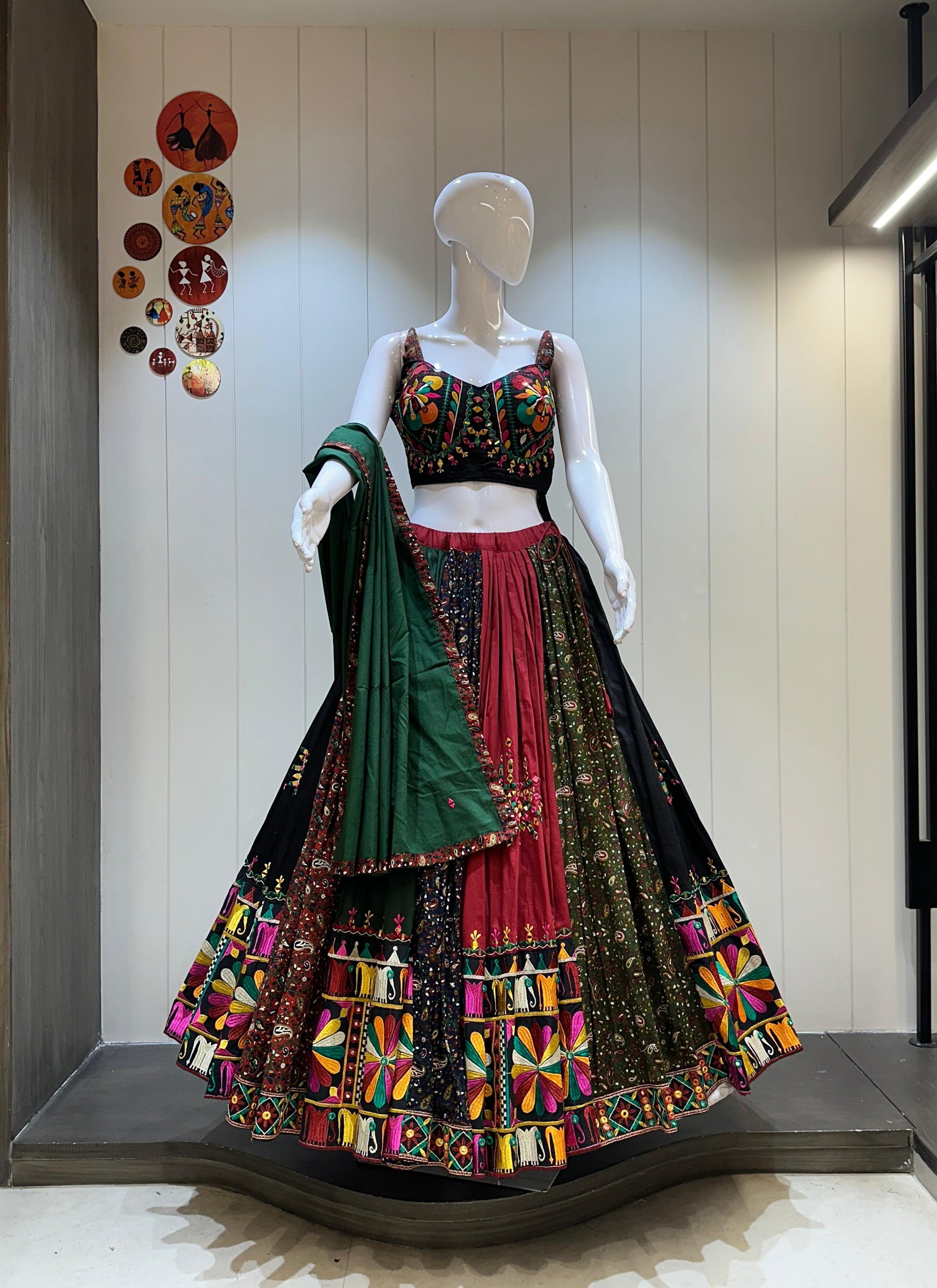 Traditional Indian outfit on a mannequin against a neutral wall.