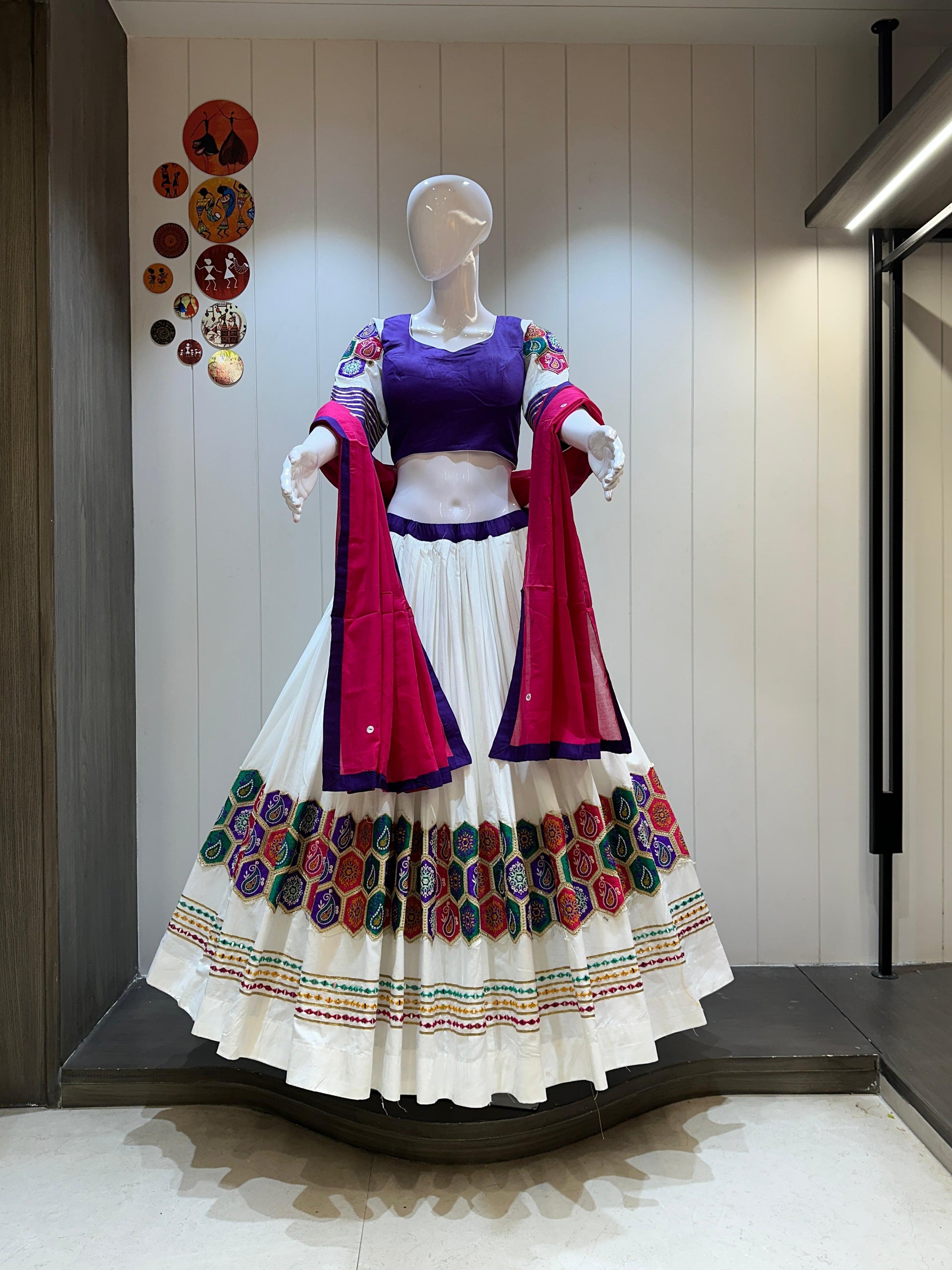 Traditional outfit displayed on a mannequin against a neutral wall.